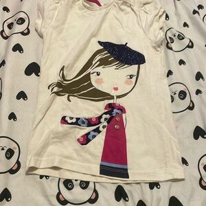 Has glitter a glow with brown hair , a pink shirt with buttons on it